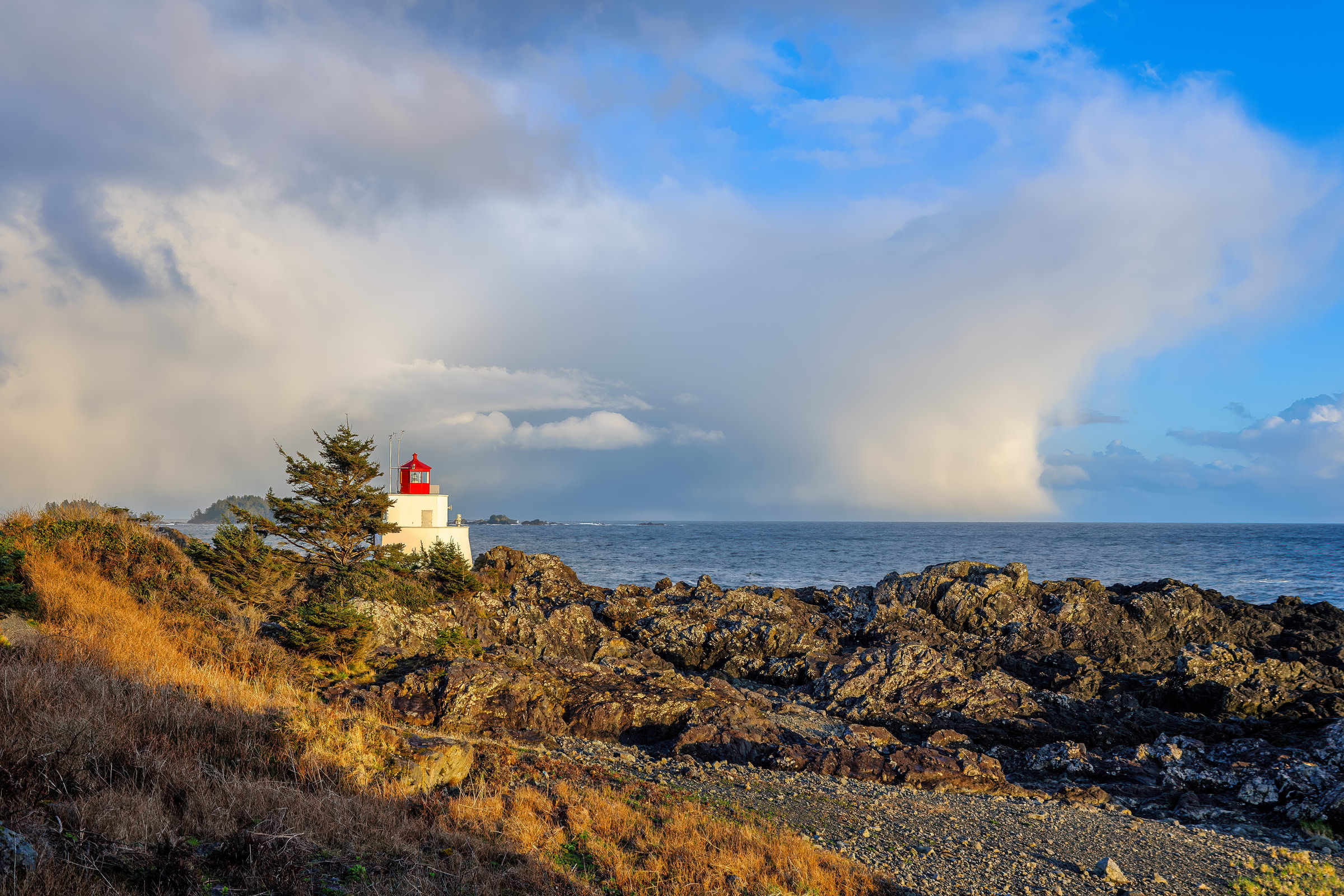 Ucluelet wall art of Amphitrite Point Lighthouse in evening sun as a storm moves out to sea, Wild Pacific Trail, BC, by James Wheeler.