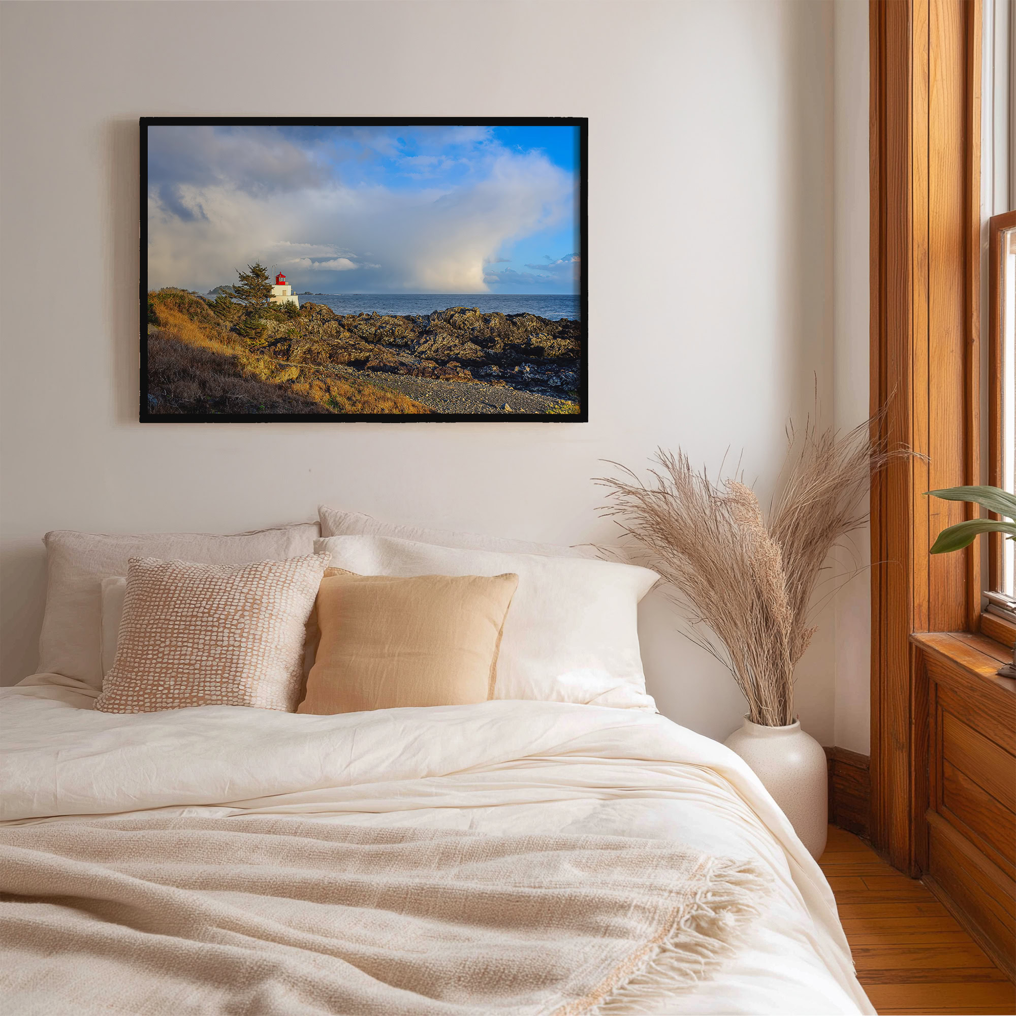 Amphitrite Point Lighthouse Storm Clouds print shown on the wall in a bedroom.