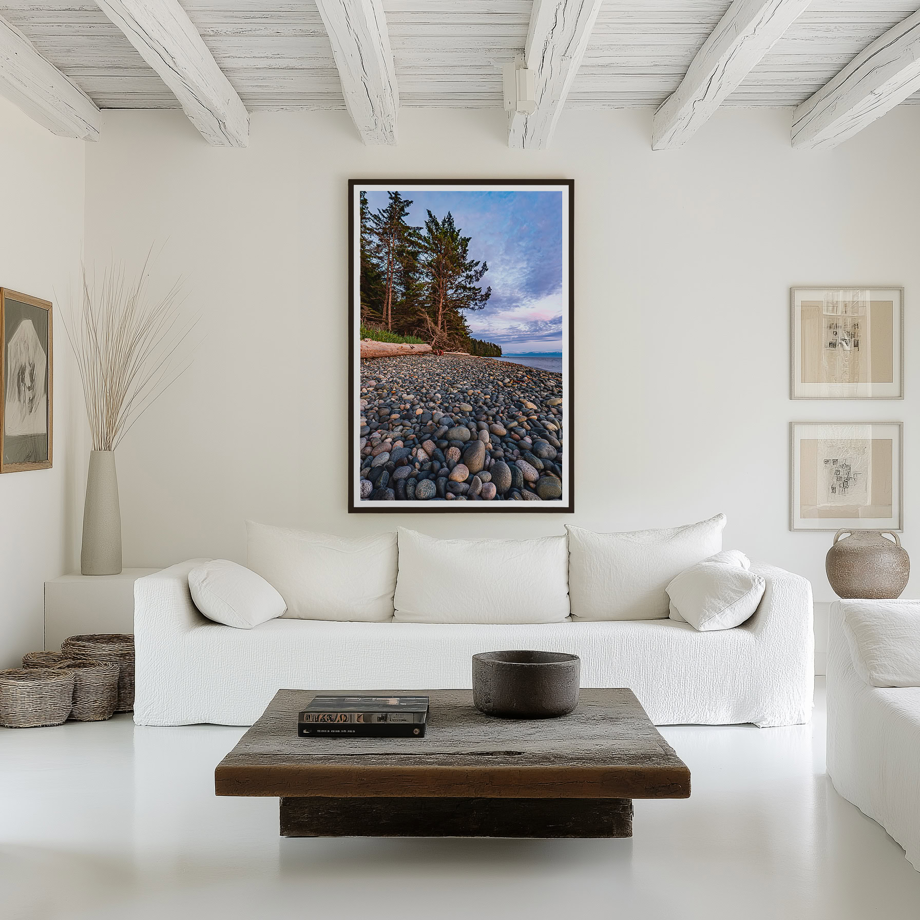 Evening Light on French Beach Stones print shown on the wall in a living room.