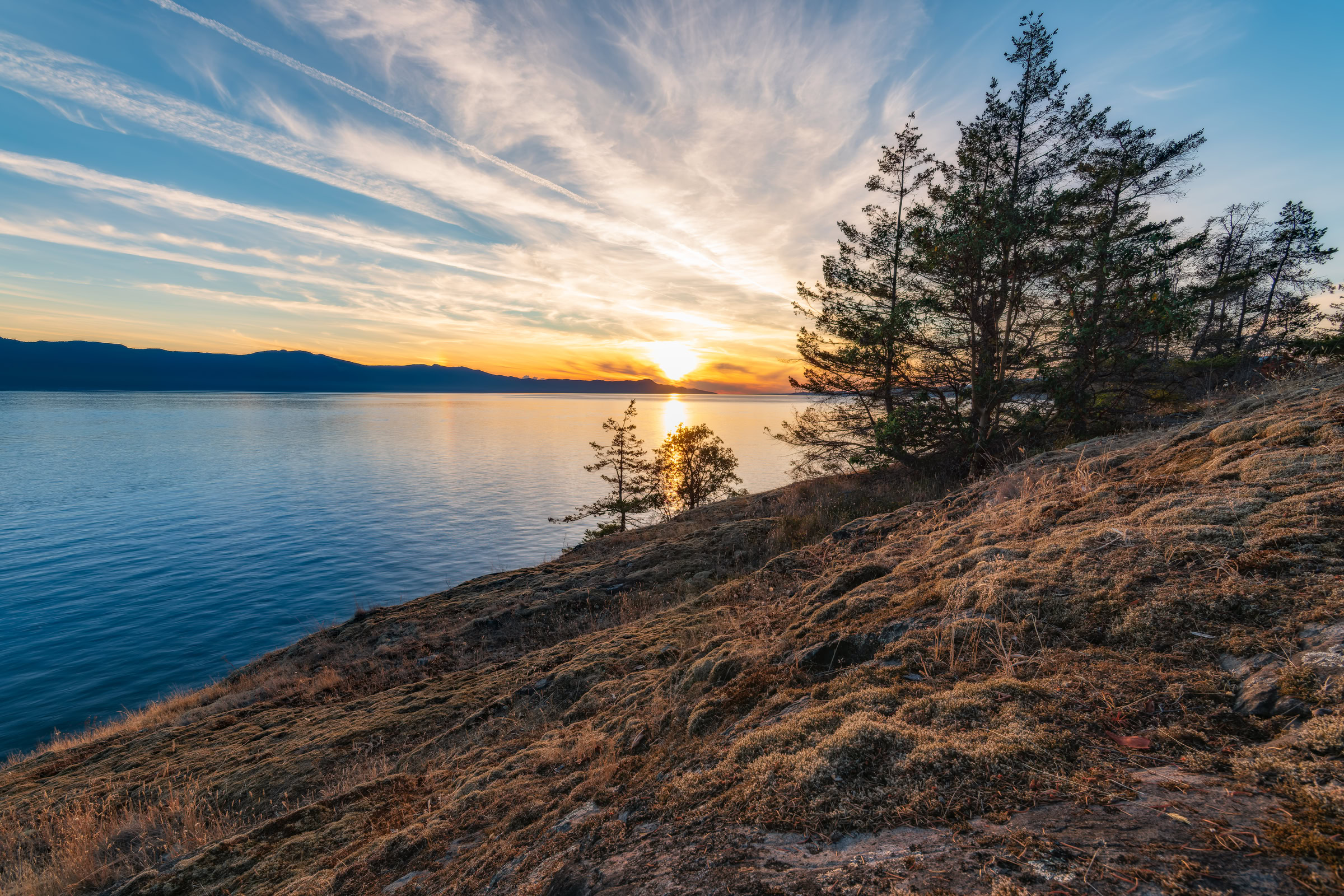 Francis Point Provincial Park wall art of the sun setting past Texada Island from a mossy bluff near Madeira Park, BC, by James Wheeler.