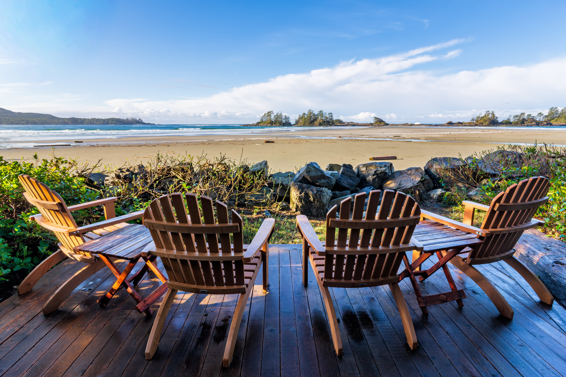 Chesterman Beach Tofino wall art of four wooden deck chairs facing the low-tide sand and islands on an April morning, BC, by James Wheeler.