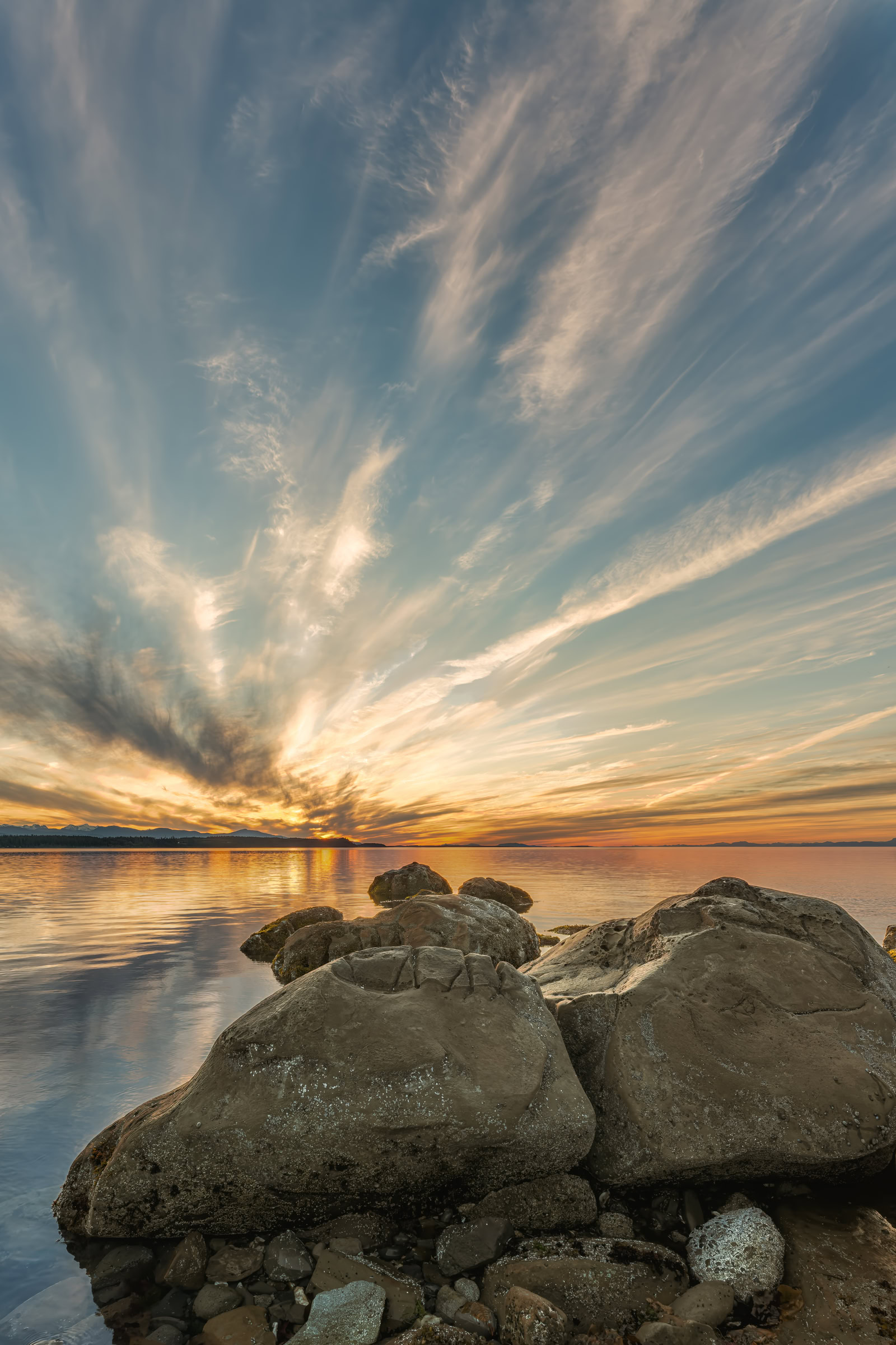 Hornby Island sunset print showing feathered clouds fanning over sandstone boulders at Phipps Point in late June, BC, by James Wheeler.