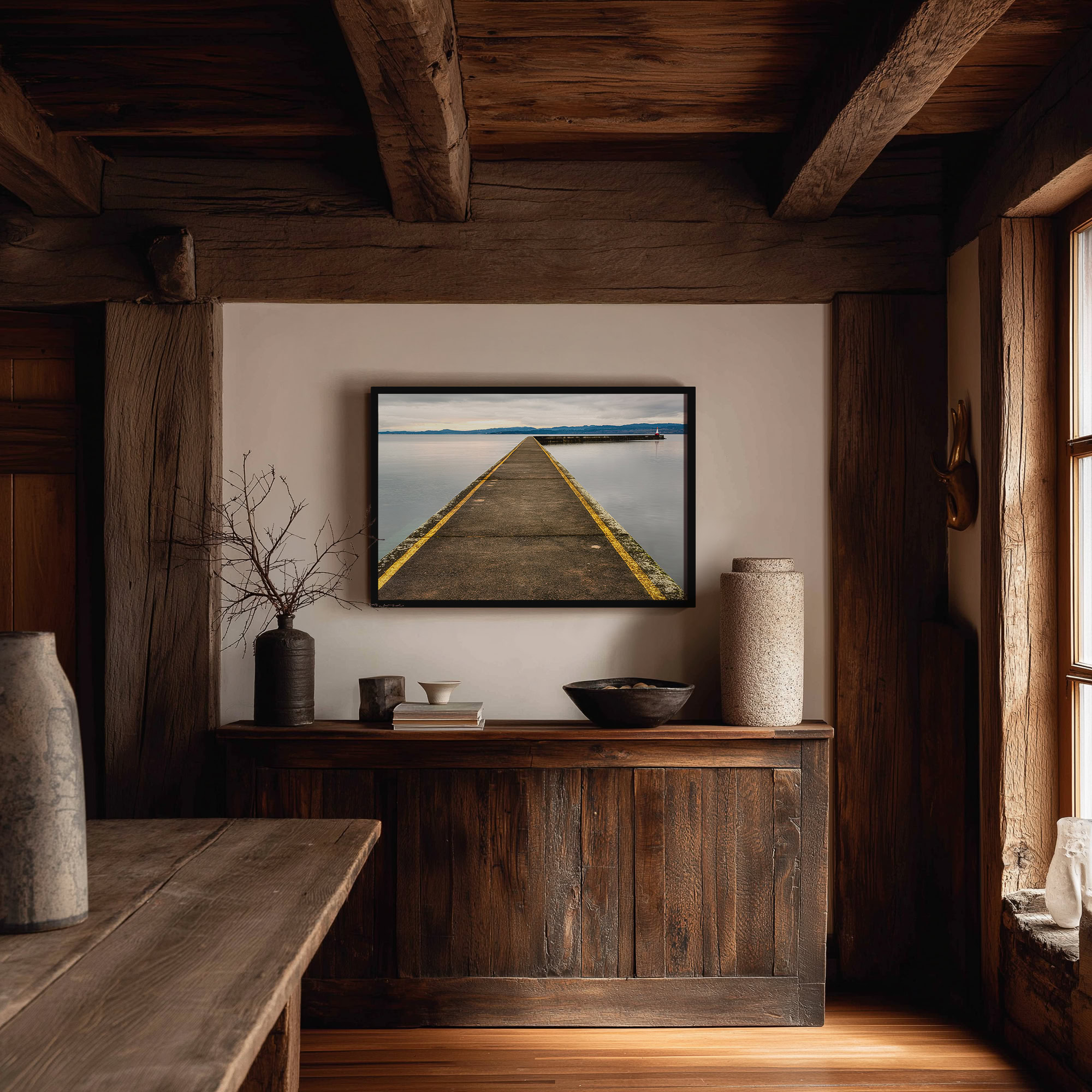 Ogden Point Breakwater Pier print shown on the wall in a styled room.