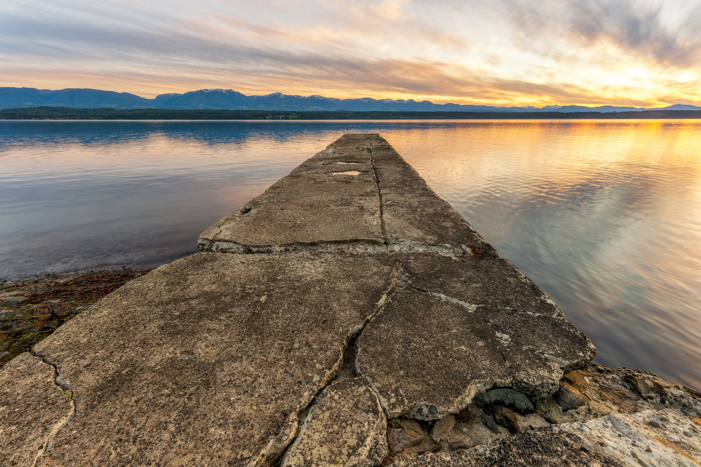 Hornby Island photo print showing the cracked concrete pier at Phipps Point at sunset over Lambert Channel, BC, by James Wheeler.