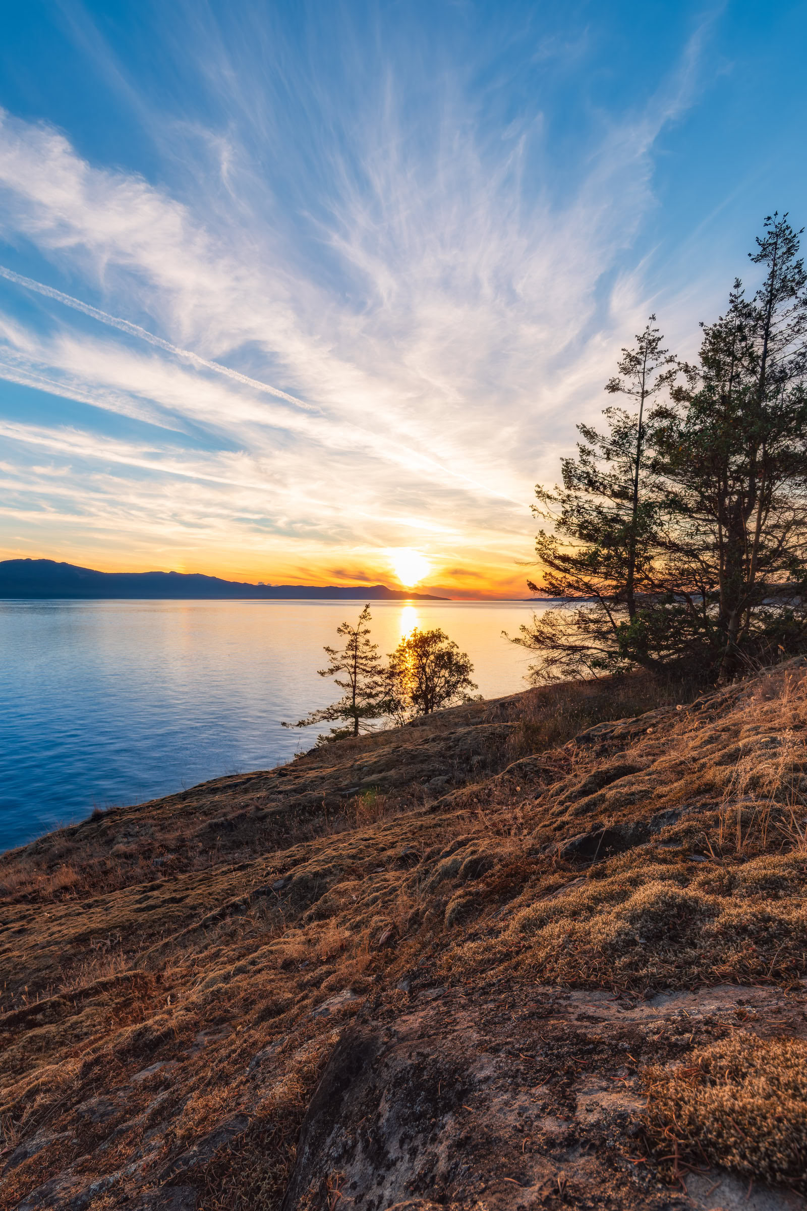 Sunshine Coast BC shoreline print of moss-covered rock at Francis Point at sunset over Texada Island and Malaspina Strait, BC, by James Wheeler.