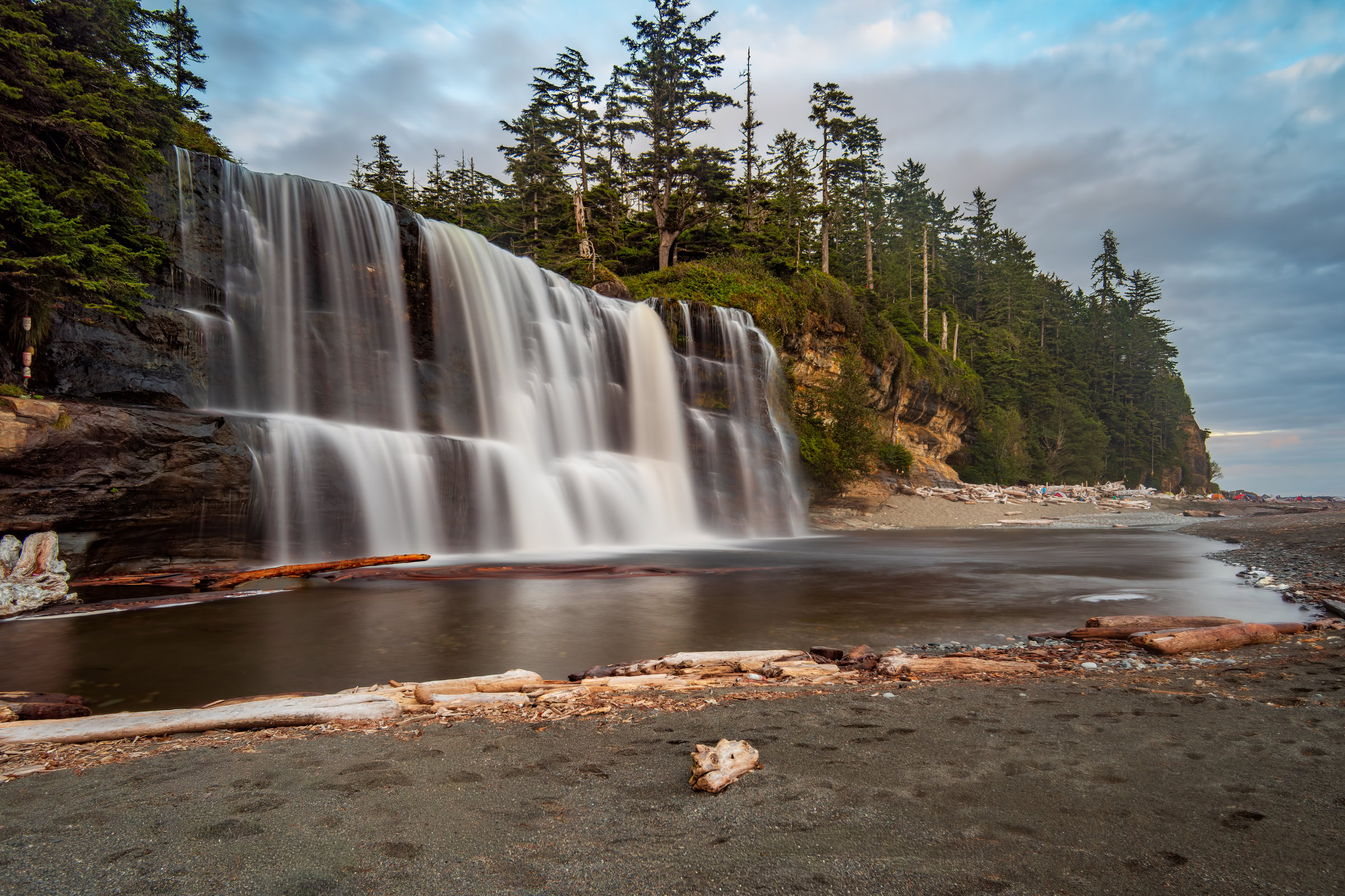 Tsusiat Falls wall art showing the wide waterfall pouring onto the beach at the West Coast Trail campsite, water smoothed by a one-second exposure, Vancouver Island, BC, by James Wheeler.